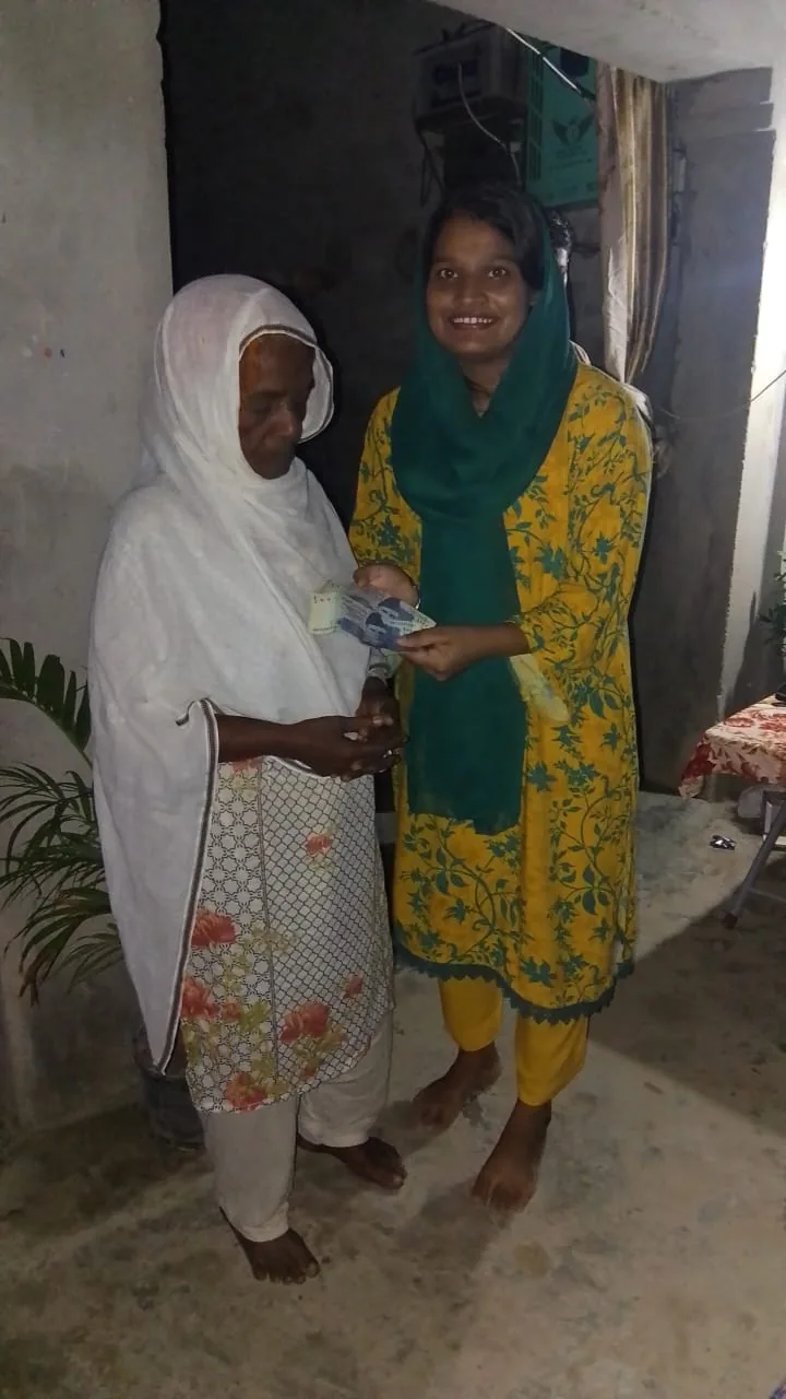 Support visit with an older community member in Pakistan