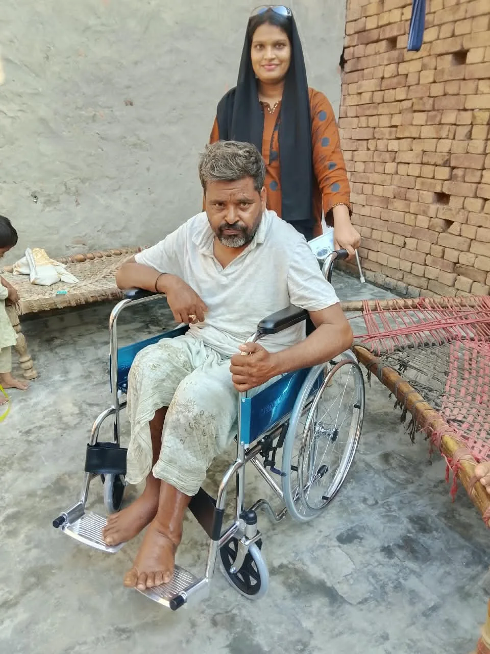 A community member using a wheelchair with others nearby