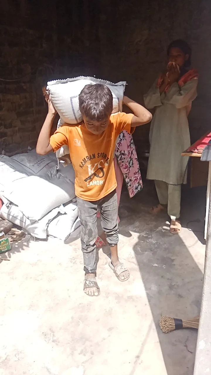 A young person carrying a sack of supplies